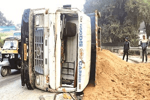 गोलचक्कर में मुड़ने के दौरान बालू लदा हाइवा सड़क पर पलटा